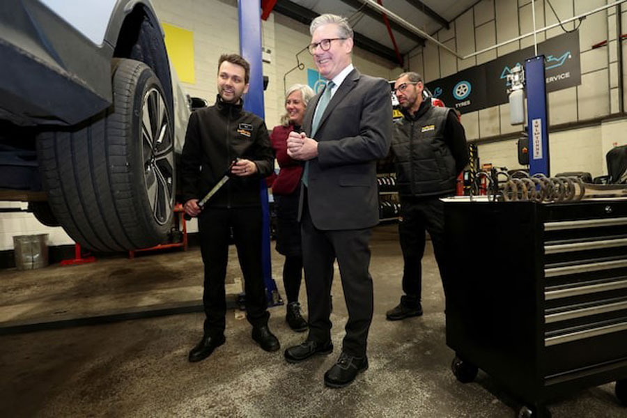 Britain's Prime Minister Keir Starmer visits a local mechanics business, following the British government's announcement of investments to maintain roads across the UK, in Cambridge, Cambridgeshire, Britain, March 24, 2025.