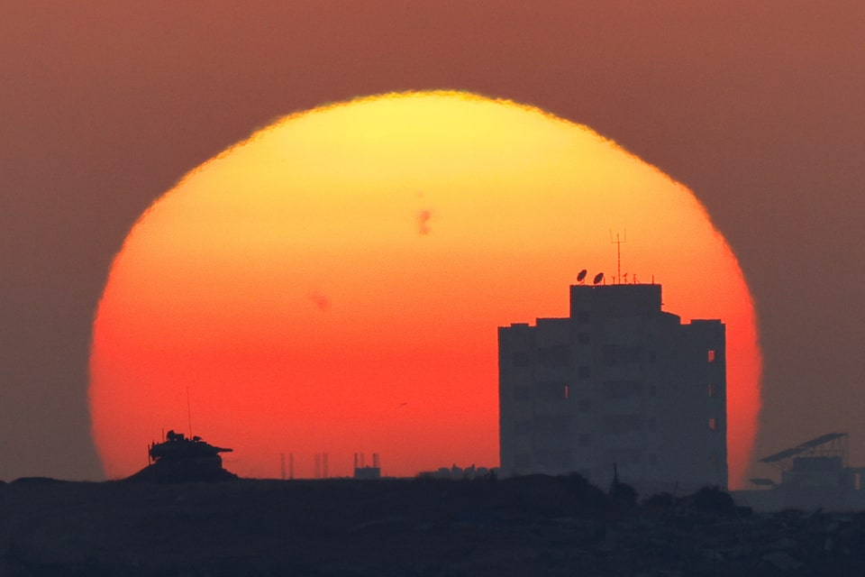 An Israeli tank is used in Gaza, near the Israel-Gaza border, as seen from Israel, May 29, 2025. REUTERS/Amir Cohen