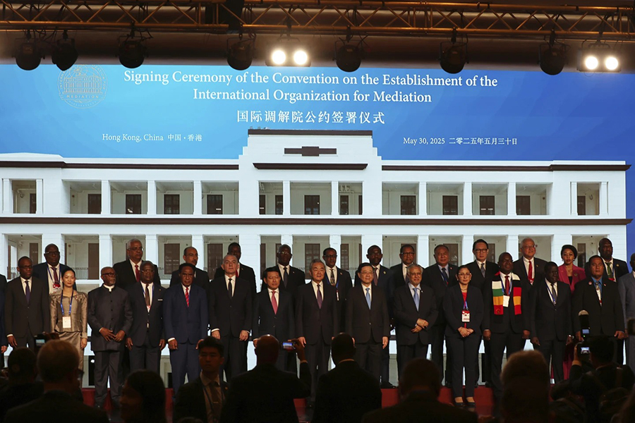 Chinese Foreign Minister Wang Yi, center, attends the signing ceremony of “the Convention on the Establishment of the International Organization for Mediation”, in Hong Kong, Friday on May 30, 2025 — AP photo