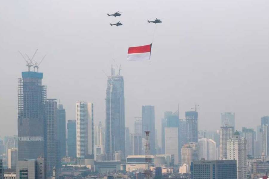 Indonesian Air Force helicopters carrying a big flag fly above high rise buildings during the country’s 76th Independence Day celebrations in Jakarta, Indonesia, Aug 17, 2021.