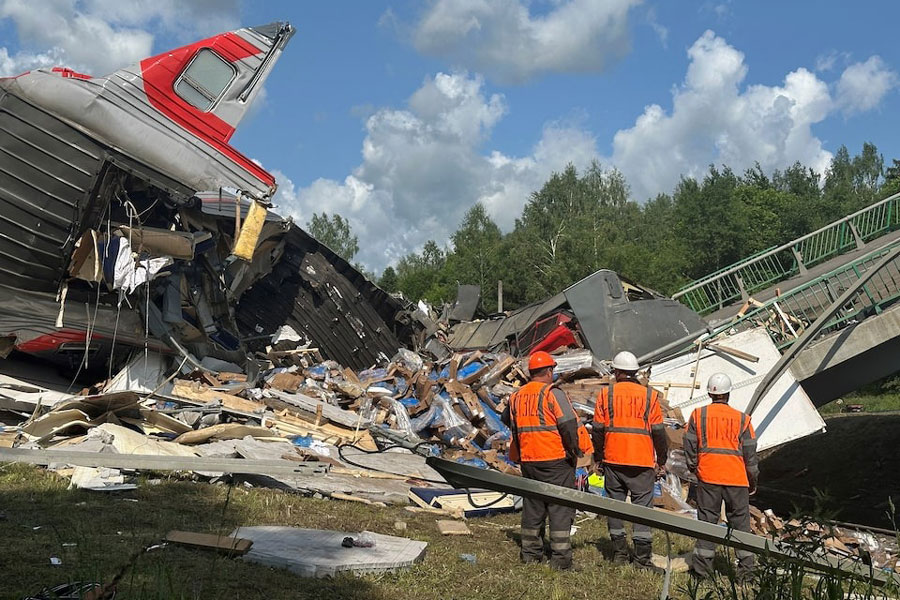 Specialists of emergency services work at the scene, after a road bridge collapsed onto railway tracks due to an explosion in the Bryansk region, Russia, June 1, 2025.