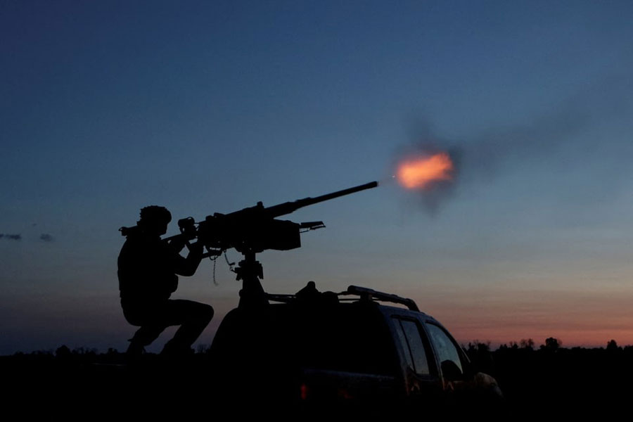 A serviceman from the mobile air defence unit of the 115th Separate Mechanized Brigade of the Ukrainian Armed Forces fires a Browning machine gun towards a Russian drone during an overnight shift, amid Russia's attack on Ukraine, in Kharkiv Region, Ukraine June 2, 2025.