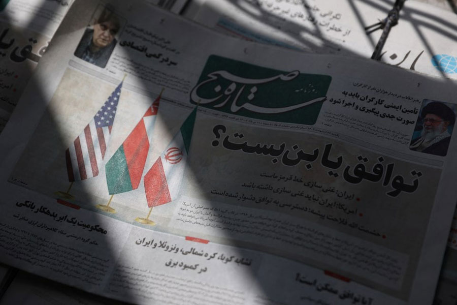An Iranian newspaper with a cover photo of Iran, Oman and US Flags, is seen in Tehran, Iran, May 11, 2025.