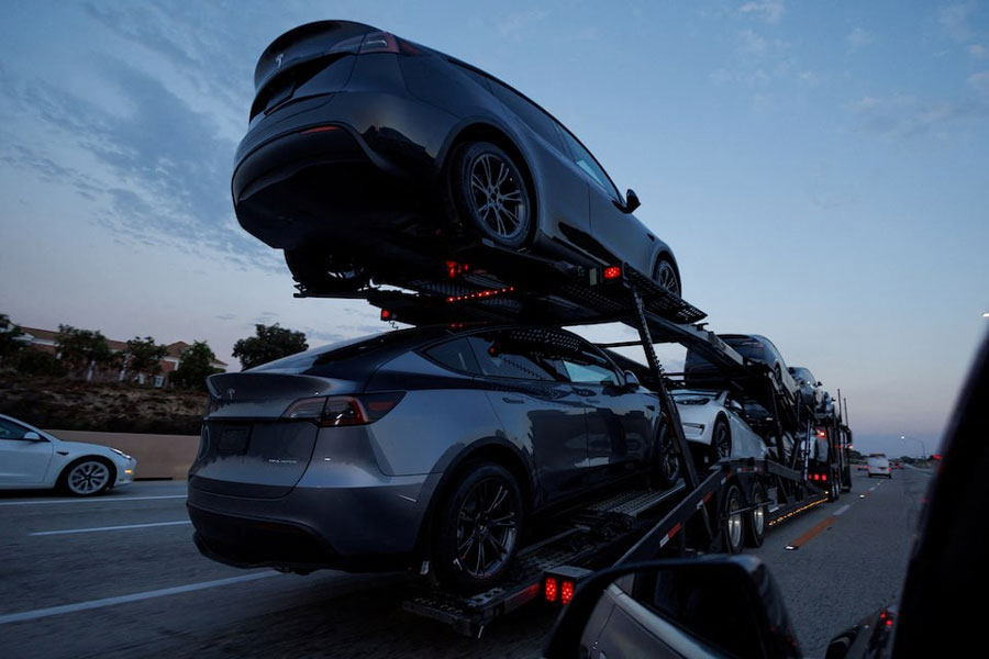 Newly manufactured Tesla Model Y SUV vehicles are transported along a freeway near Carlsbad, California, US, September 9, 2024.