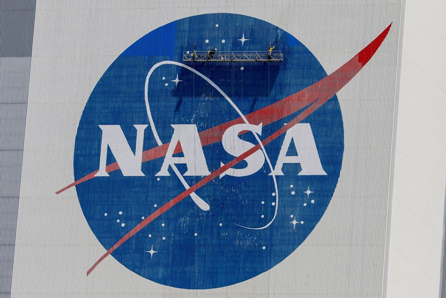 Workers pressure wash the logo of NASA on the Vehicle Assembly Building before SpaceX will send two NASA astronauts to the International Space Station aboard its Falcon 9 rocket, at the Kennedy Space Center in Cape Canaveral, Florida, US on May 19, 2020 — Reuters/Files