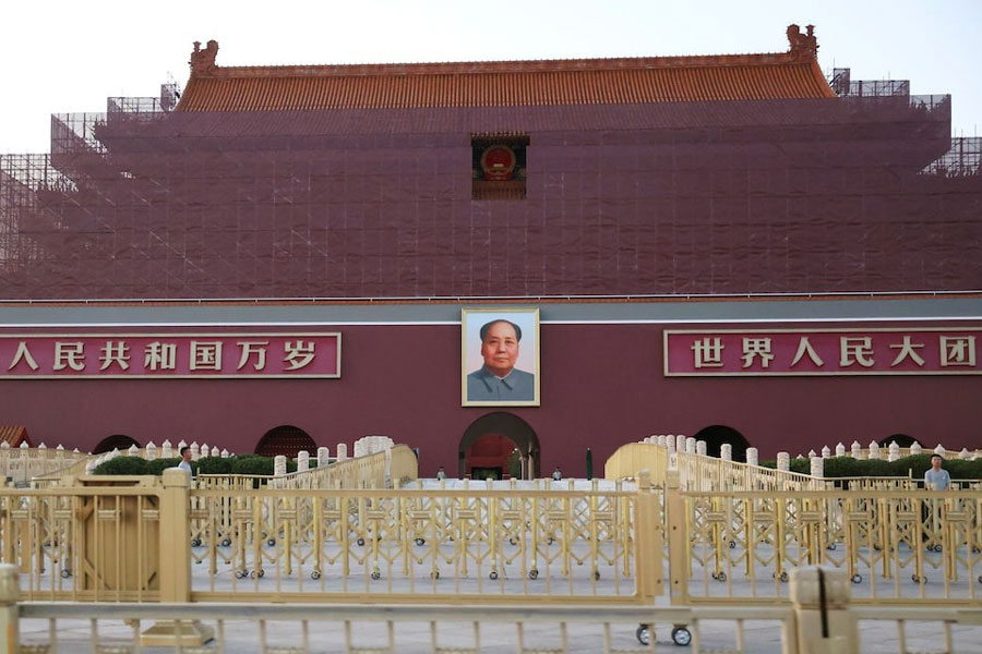 Security personnel keep watch near the portrait of late Chinese Chairman Mao Zedong displayed on the Tiananmen Gate, in Beijing, China June 3, 2025.