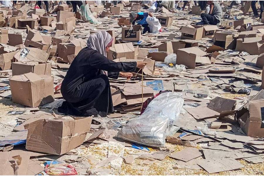 Palestinians gather to collect what remains of relief supplies from the distribution center of the U.S.-backed Gaza Humanitarian Foundation, in Rafah, in the southern Gaza Strip, June 5, 2025.