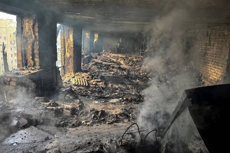 Firefighters work inside an apartment building hit by a Russian drone strike, amid Russia's attack on Ukraine, in Kharkiv, Ukraine June 7, 2025.