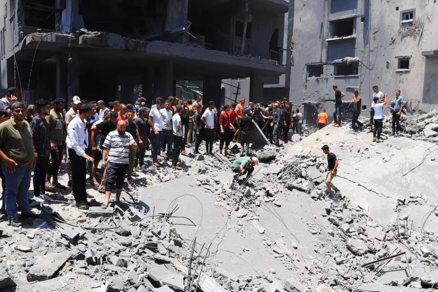 Palestinians search for casualties at the site of an Israeli strike on a house, in Gaza City, June 7, 2025.