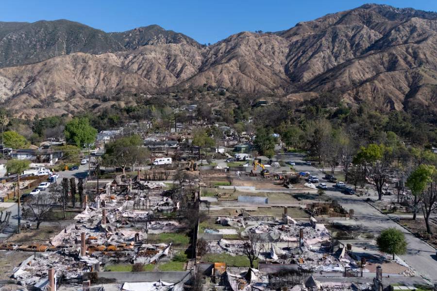 A drone view shows workers cleaning debris from destroyed homes for residents of the Eaton Fire in Altadena, California, U.S., March 10, 2025.
