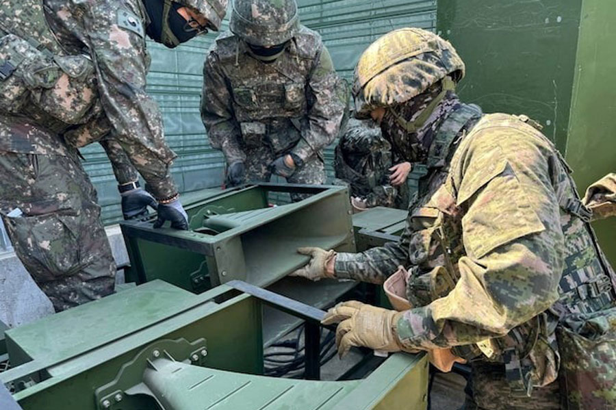 South Korean soldiers work on a loudspeaker that is set up for propaganda broadcasts during a military drill near the demilitarized zone separating the two Koreas in Paju, South Korea, in this handout picture provided by the Defense Ministry and released on June 9, 2024.