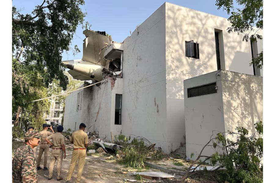 A tail of an Air India Boeing 787 Dreamliner plane that crashed is seen stuck on a building after the incident in Ahmedabad, India, June 12, 2025.