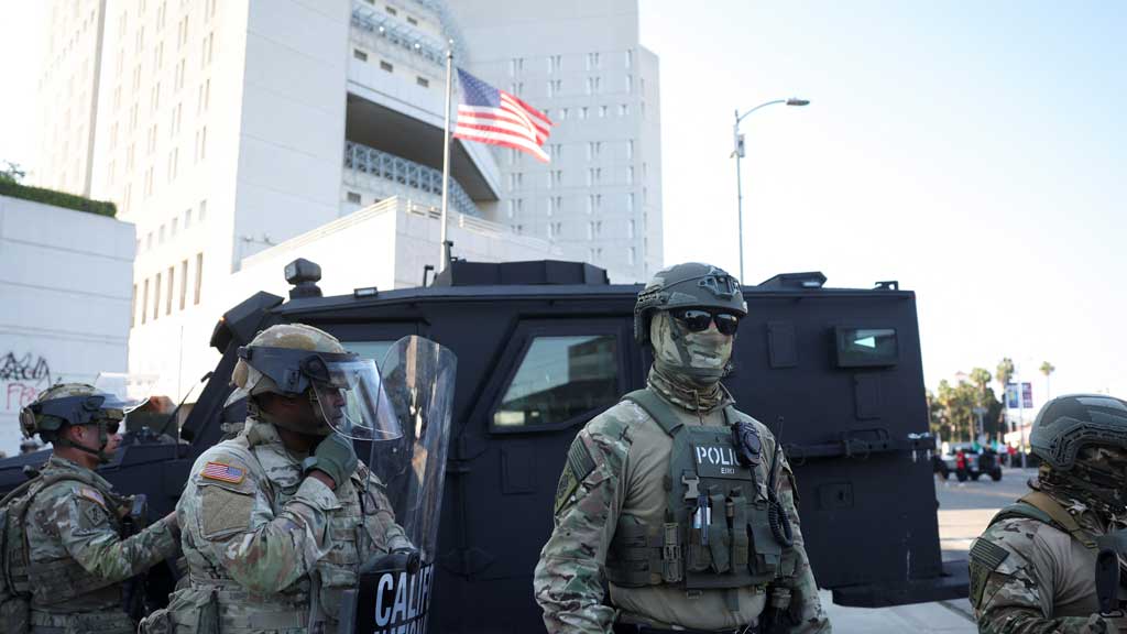 National Guard members stand guard during a protest against federal immigration sweeps, outside Metropolitan Detention Center in Los Angeles, California, US, June 12, 2025. REUTERS