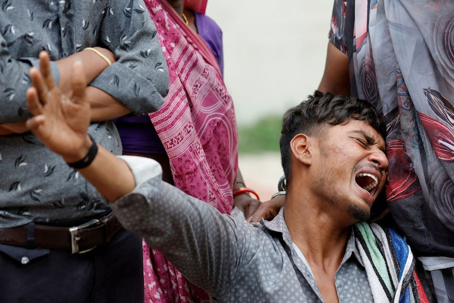 Kalpeshbhai Patni, 28, mourns as he sits outside the postmortem room at a hospital, for his brother Akash Patni, 14, who died when an Air India Boeing 787-8 Dreamliner plane crashed during take-off from an airport, in Ahmedabad, India, June 13, 2025.