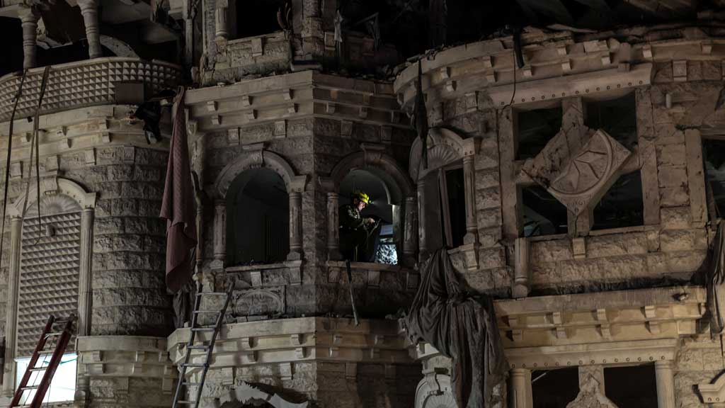 A rescue worker sits inside a residential building following the impact of missiles fired from Iran, in Tamra, Israel, June 15, 2025. REUTERS