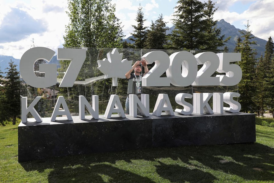 A worker prepares a sign ahead of the G7 summit at a satellite location in Banff, Alberta, Canada, June 14, 2025.