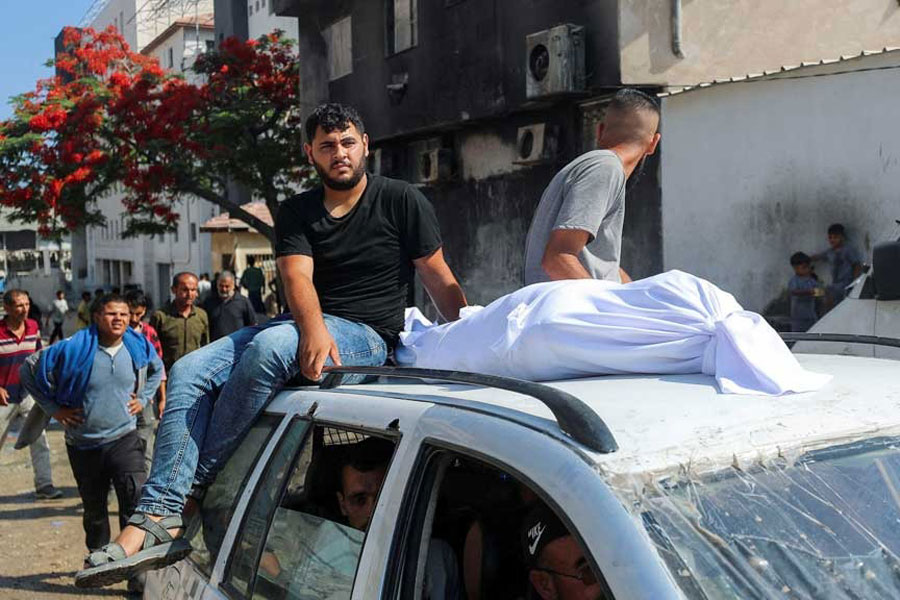 The body of a Palestinian is transported on a car as mourners attend the funeral of Palestinians who were killed, according to medics, in Israeli fire, at Al-Shifa hospital, in Gaza City, Jun 12, 2025.