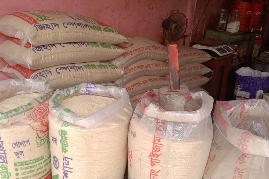 Different varieties of rice on display at a shop in Bogura