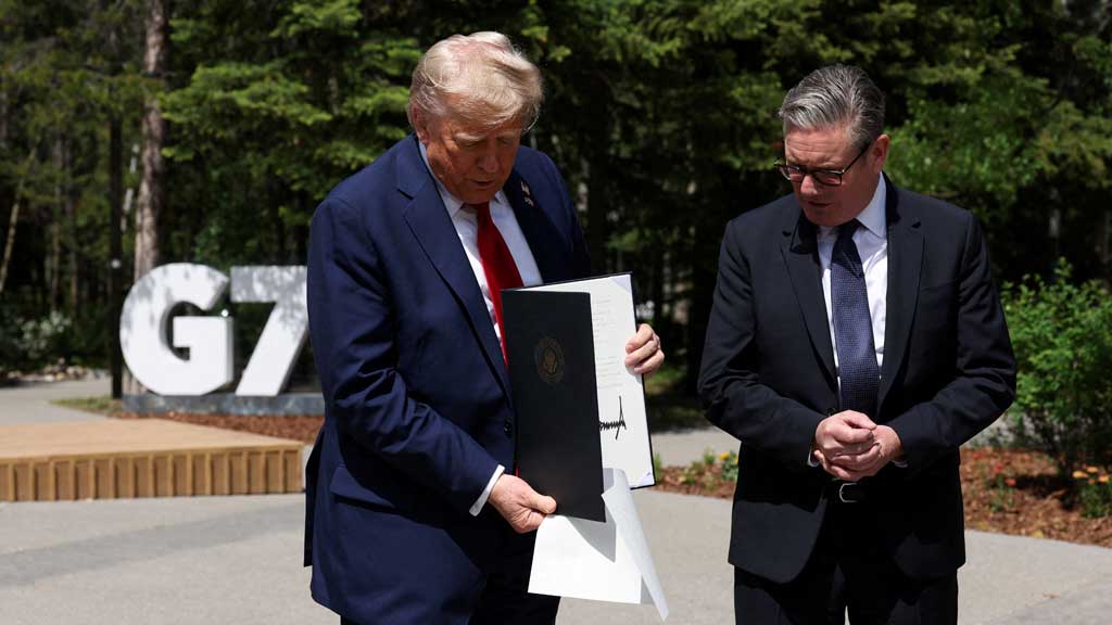 US President Donald Trump holds a signed Trade Agreement with Britain during a meeting with British Prime Minister Keir Starmer, at the G7 summit, in Kananaskis, Alberta, Canada, June 16, 2025. REUTERS