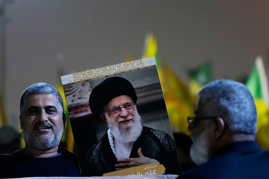 A protester holds a portrait of Iran's Supreme Leader Ayatollah Ali Khamenei during a protest against Israeli attacks on multiple cities across Iran, at a bridge leading to the fortified Green Zone where the U.S. Embassy is located in Baghdad, Iraq, on Wednesday, June 18, 2025 — AP photo