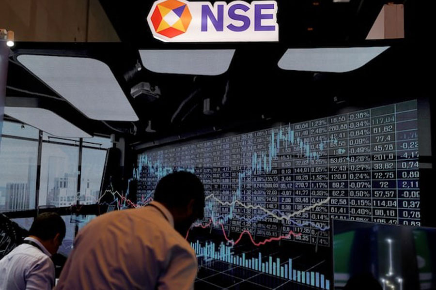 People work at the National Stock Exchange (NSE) stall during the Global Fintech Fest in Mumbai, India, August 29, 2024.