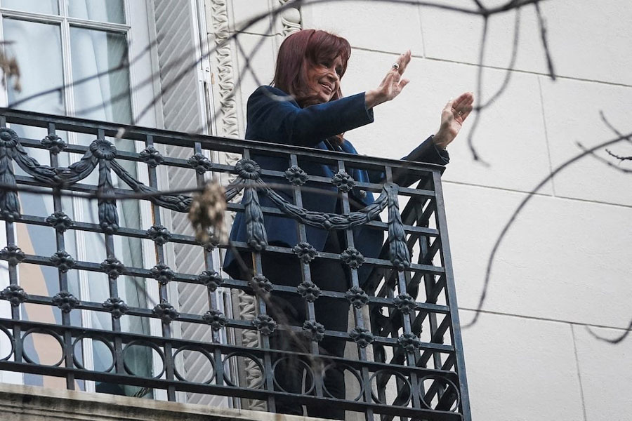 Former Argentinian President Cristina Fernandez de Kirchner gestures from the balcony of her home after Argentina's Supreme Court upheld her guilty verdict for defrauding the state, in Buenos Aires, Argentina, June 13, 2025.