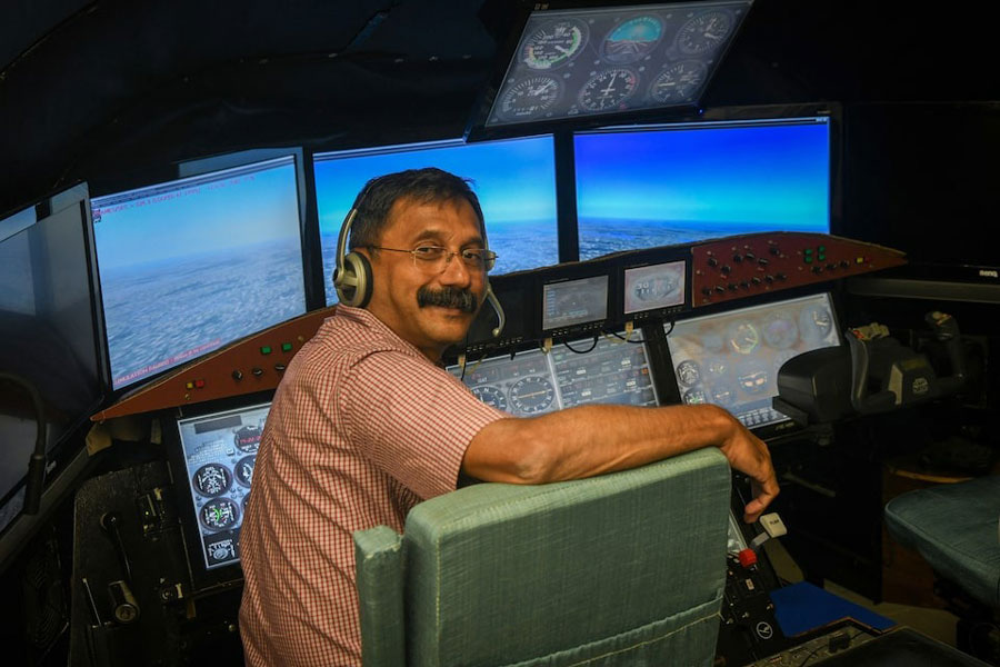 Retired Indian Air Force (IAF) wing commander Dinesh K poses for pictures in a cockpit simulator room, after an interview with Reuters, at Cockpit Vista in Bengaluru, India June 23, 2025.