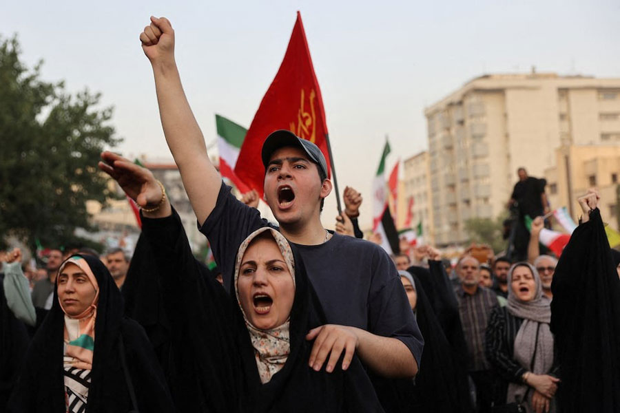 People gesture as they attend a gathering to support Iran's Armed Forces, after US President Donald Trump announced a ceasefire between Israel and Iran, in Tehran, Iran, June 24, 2025.