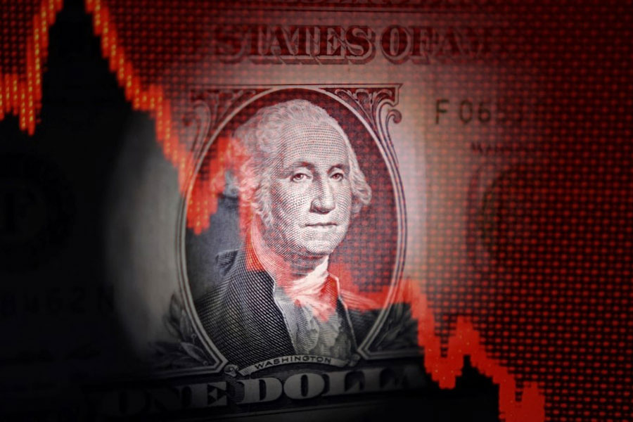 US dollar banknote and decreasing stock graph are seen in this illustration taken April 25, 2025.