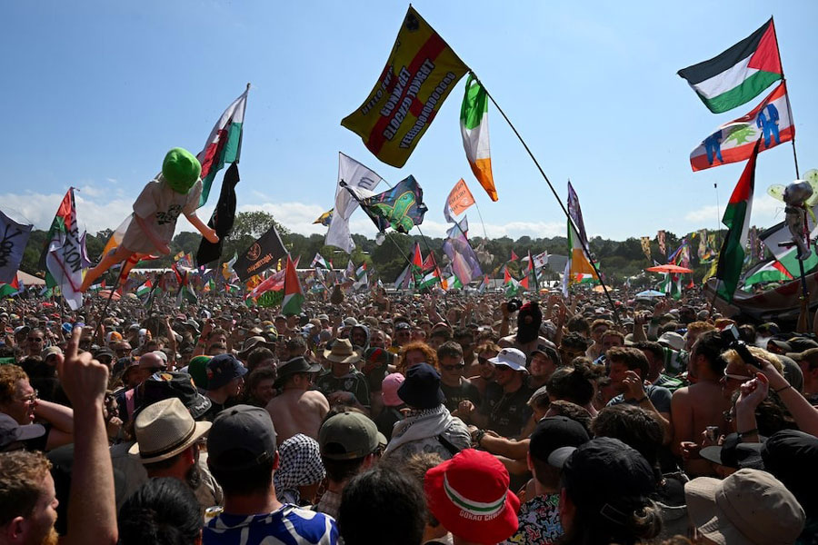 Revellers gather as Kneecap performs at Glastonbury Festival at Worthy Farm in Pilton, Somerset, Britain, June 28, 2025.