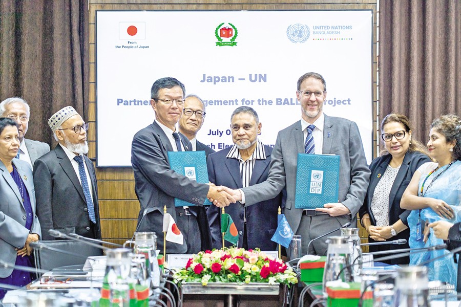 Japanese Ambassador Saida Shinichi and UNDP Resident Representative Stefan Liller shaking hands after signing an agreement in the capital on Wednesday. Director General of International Cooperation Bureau, Ministry of Foreign Affairs of Japan Ishiizuki Hideo and Chief Election Commissioner of Bangladesh AMM Nasir Uddin were also present on the occasion, among others