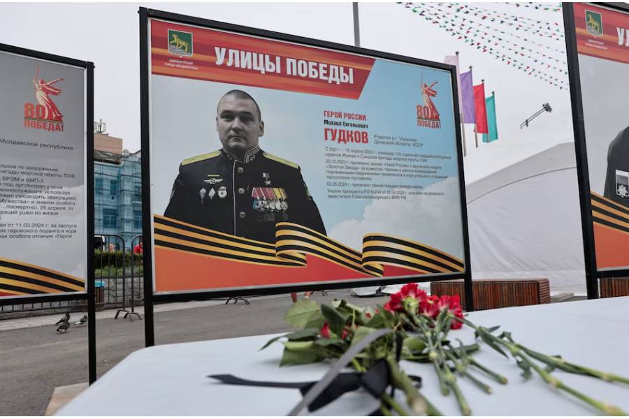 A view shows flowers placed in front of a board with a photograph of Major General Mikhail Gudkov, the deputy head of the Russian Navy who, according to local authorities, was recently killed in the Kursk region amid Russia-Ukraine conflict, at an exhibition of distinguished Russian soldiers' portraits in the far eastern city of Vladivostok, Russia, July 3, 2025.