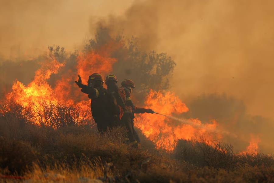 Firefighters try to extinguish a wildfire near Ierapetra, on the island of Crete, Greece, July 3, 2025.