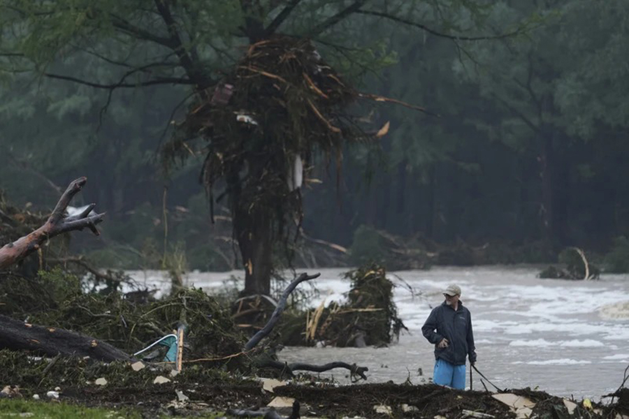 A man surveys debris along the Guadalupe River after a flash flood struck the area on Friday, July 4, 2025, in Kerrville, Texas — AP photo