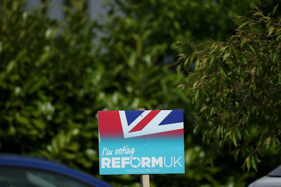 A Reform UK party poster is seen outside a house ahead of the forthcoming Runcorn and Helsby parliamentary by-election in Frodsham, Britain, April 25, 2025.