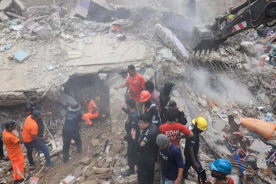 Rescue workers search for survivors as they go through the rubble of a five-storey residential building, which collapsed in Karachi, Pakistan July 4, 2025.