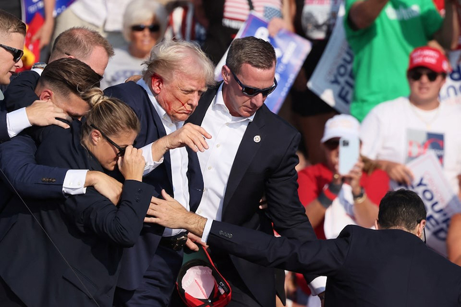 Republican presidential candidate and former US President Donald Trump with his bloodied face is assisted by the Secret Service as multiple shots rang out during a campaign rally at the Butler Farm Show in Butler, Pennsylvania, US on July 13, 2024 — Reuters/File