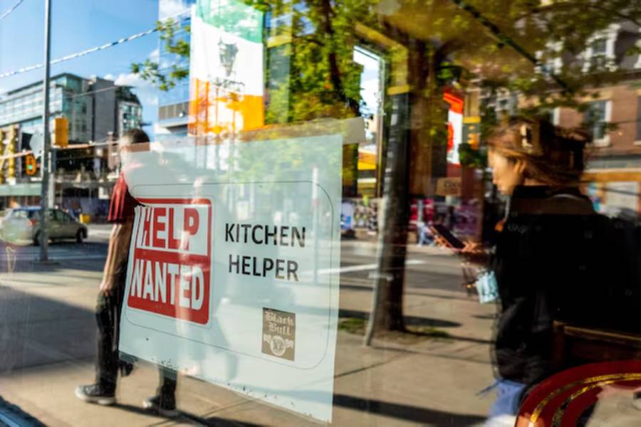 A help wanted sign hangs in a bar window along Queen Street West in Toronto Ontario, Canada June 10, 2022.