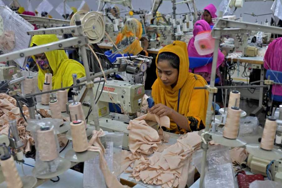 Workers sew garments inside the sewing section of a garment factory in Ashulia, on the outskirts of Dhaka, Bangladesh, Apr 19, 2025.
