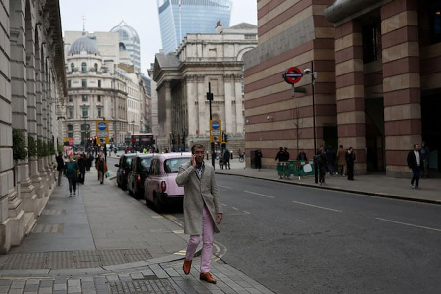 An office worker walks by the City of London financial district, in London, Britain, January 17, 2025.