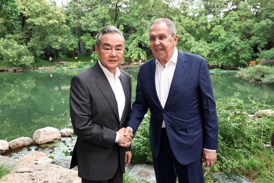 Chinese Foreign Minister Wang Yi shakes hands with Russian Foreign Minister Sergei Lavrov during a meeting on the sidelines of the Shanghai Cooperation Organisation (SCO) Foreign Ministers' Council meeting in Beijing, China July 13, 2025.