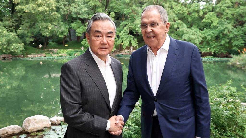 Chinese Foreign Minister Wang Yi shakes hands with Russian Foreign Minister Sergei Lavrov during a meeting on the sidelines of the Shanghai Cooperation Organisation (SCO) Foreign Ministers' Council meeting in Beijing, China Jul 13, 2025. Russian Foreign Ministry/Handout via REUTERS ATTENTION