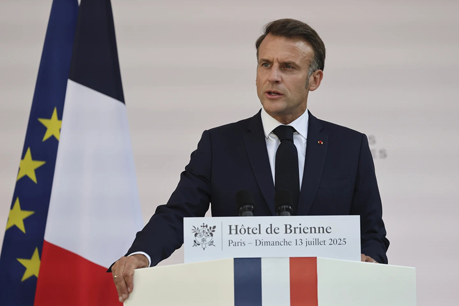 French President Emmanuel Macron speaks to the army leaders flanked by Prime Minister Francois Bayrou, left, and Defense Minister Sebastien Lecornu at the Hotel le Brienne on Sunday, July 13, 2025, ahead of the Bastille Day parade in Paris — Pool photo via AP