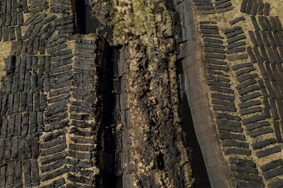 A drone view shows turf from Derryrush bog left out to dry after being harvested from the blanket bog, in Derryrush, Ireland on April 22, 2024. Ireland's bogs were formed over thousands of years as decaying plants formed a thick layer of peat in wetland areas — Reuters/File