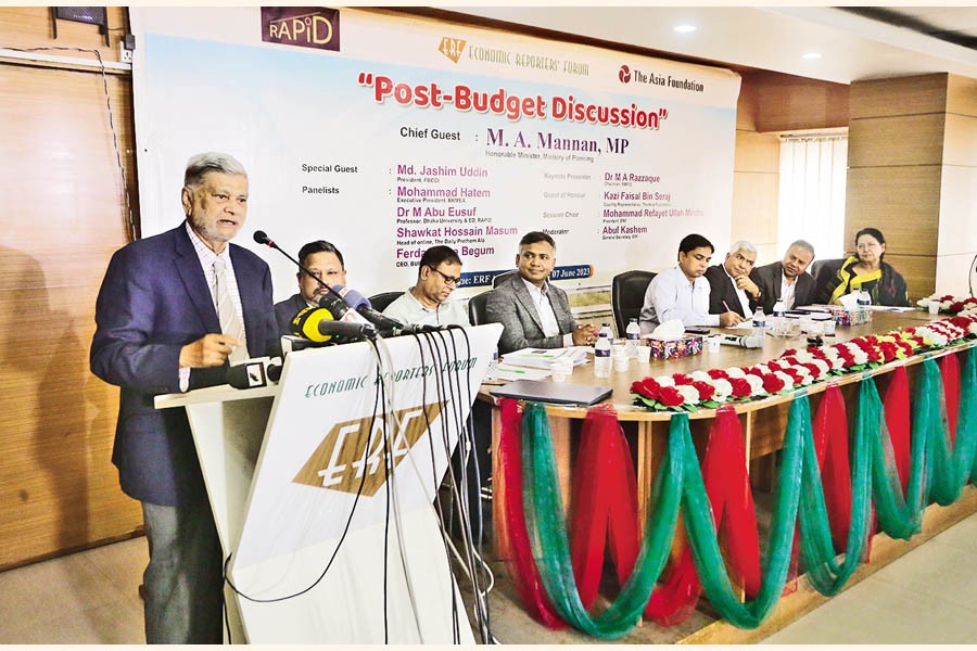 Planning Minister MA Mannan speaks as the chief guest at a post-budget discussion jointly organised by the Economic Reporters' Forum (ERF) and RAPID, held at the ERF auditorium in Dhaka on Wednesday. — FE photo