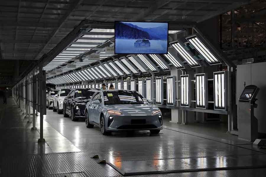 Employees work on the production line at a factory of Chinese electric vehicle (EV) maker Nio in Hefei, Anhui province, China April 2, 2025.