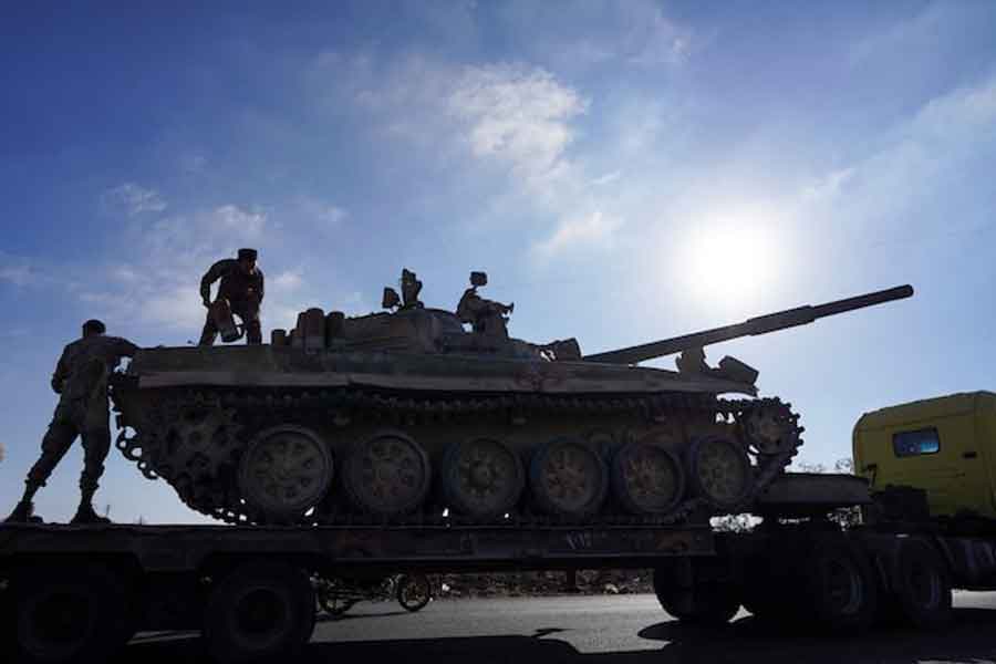 A member of the Syrian security forces stands on a military vehicle after Syrian troops entered the predominantly Druze city of Sweida on Tuesday following two days of clashes, in Sweida, Syria July 15, 2025.