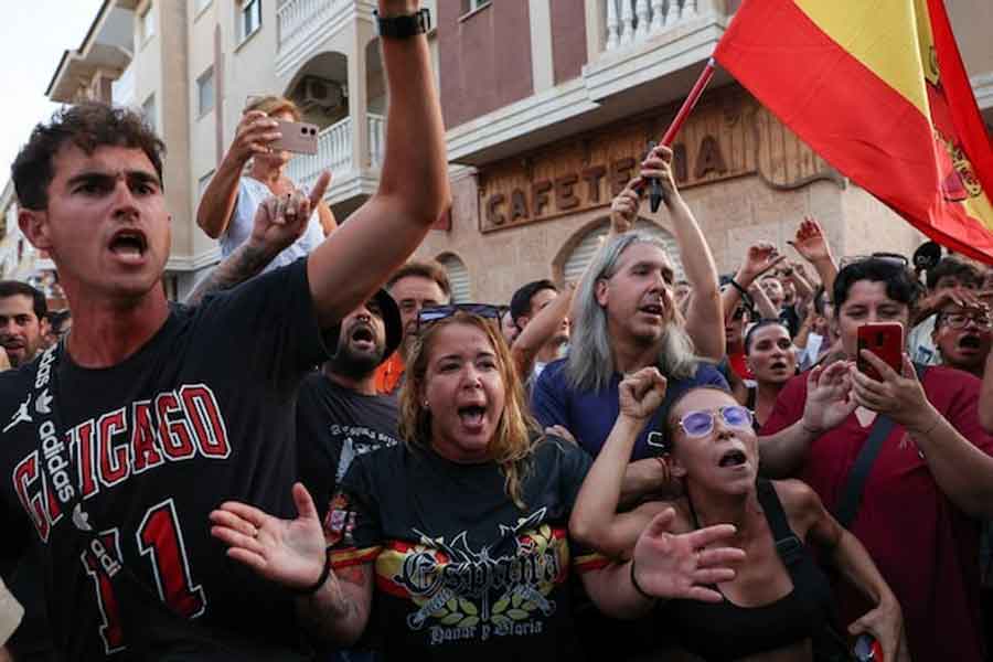 A demonstrator gestures while wearing a shirt reading, "Spain. Honour and Glory", during anti-migrant unrest, following an attack on an elderly man by unknown assailants last week, in Torre Pacheco, Spain, July 15, 2025.