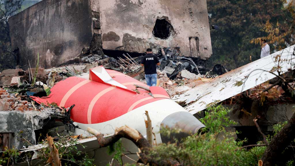 FILE PHOTO: A firefighter stands next to the crashed Air India Boeing 787-8 Dreamliner aircraft, in Ahmedabad, India, Jun 13, 2025. REUTERS/Adnan Abidi/File Photo/File Photo