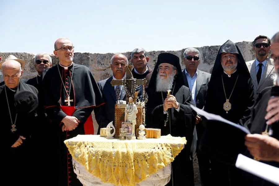 Latin Patriarch in Jerusalem, Pierbattista Pizzaballa, and Greek Orthodox patriarch of Jerusalem, Theophilos III, look on during the visit to the town of Taybeh, a Christian village in the Israeli-occupied West Bank, following settler attacks, July 14, 2025.